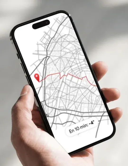 Concept image of a phone showing a Paris street map with a route line and a pill reading En 10 min: -4 degrees